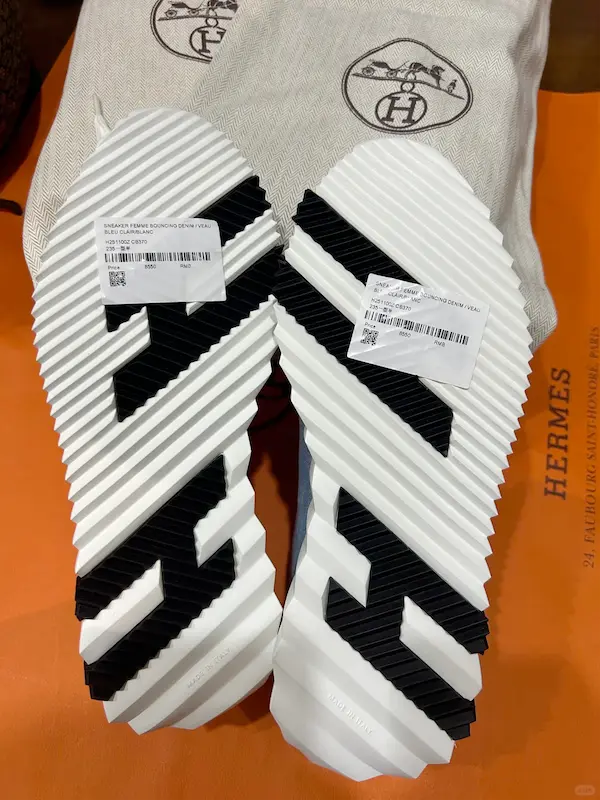 Value-priced Hermes sneakers with quality rubber outsole Closeup of denim replica sneaker sole with $179 price tag - gripper tread detail