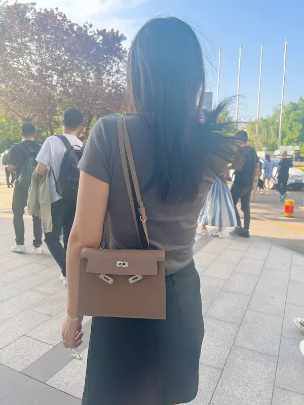 Side view of Etoupe Grey Hermes Kelly Danse replica showing strap adjustment and leather texture