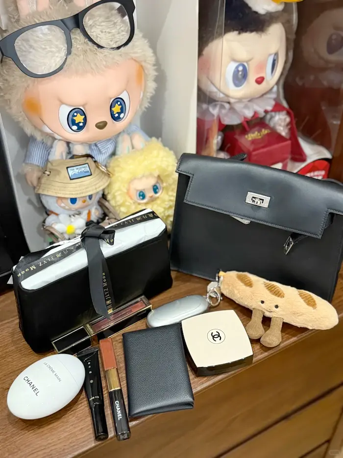 Noir Black Replica Hermes Kelly Danse displayed on marble table with luxury accessories