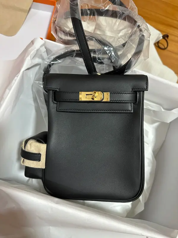 Detail of Black Replica Kelly Jump Gold Hardware Close-up detail shot of Black Replica Hermes Kelly Jump Backpack with Gold Hardware