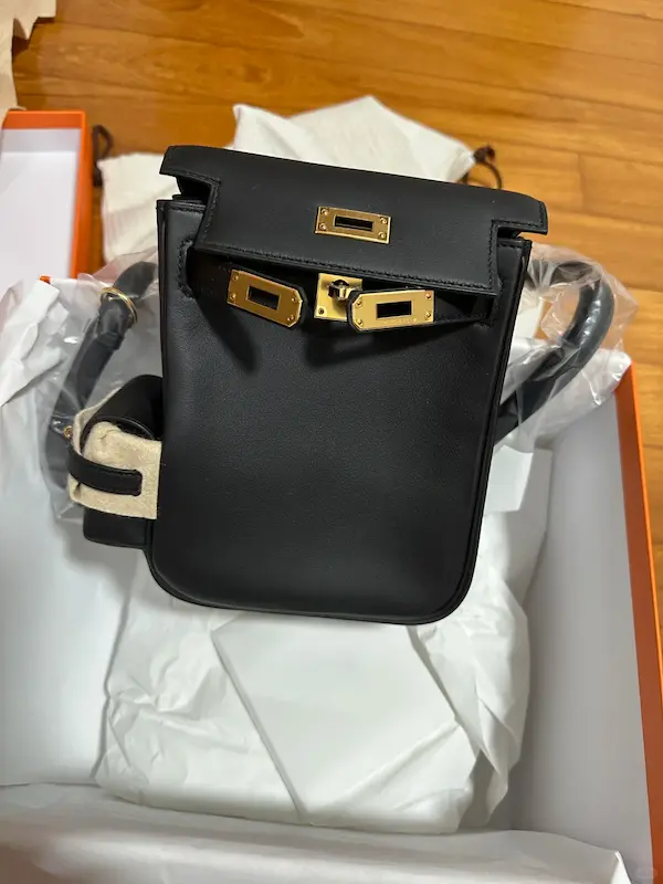 Side View of Black Replica Kelly Backpack Side profile view of the Black Hermes Kelly Jump Backpack Replica showcasing its structure