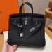 Side profile showing the sturdy silver sangles and plaqué on the best replica Hermes black Birkin 25.