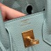 Rear view of the best replica Hermes Blue Atoll Birkin 25, showcasing the gold pocket and silver accent.