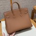 Close-up of the authentic silver lock and keys for the best replica Hermes gold Birkin 25