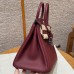 Side profile showing the sturdy silver sangles and plaqué on the best replica Hermes Rouge H Birkin 25.