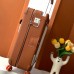 Replica Hermes R.M.S Luggage - Travel Styling Inspiration Replica Hermes R.M.S Cabin Suitcase in Gold shown in luxury travel setting.
