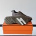 Replica Hermes Bouncing Sneaker side view, black leather with signature H detail